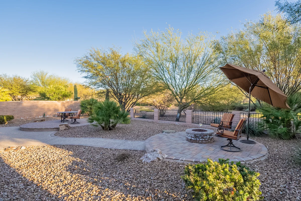 Quail Creek home patio with a fire pit, seating and desert landscaping